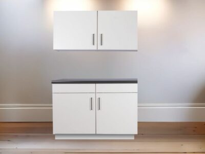 Ingezoomd Keukenblok 120 met 2 onderkasten, hangkasten en antraciet werkblad. Op een houten vloer in verlichte kamer met houten vloer.